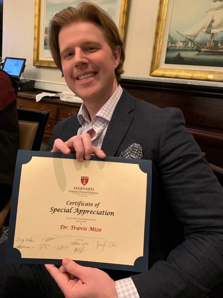 Dr. Travis W. Mize holding his Harvard Certificate of Special Appreciation